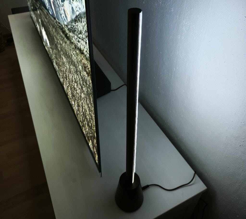 Die Philips Hue Play Table Lamp passt unauffällig neben den TV.